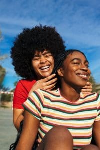 Two close friends sharing a moment of laughter