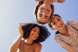 Friends laughing together, representing healthy social bonds